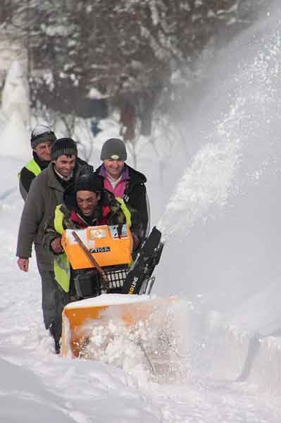 it takes a team sometimes to blow snow. Four men and a snowblower.